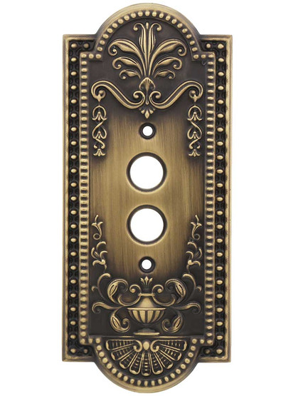 Como Single Push-Button Switch Plate in Antique Brass.